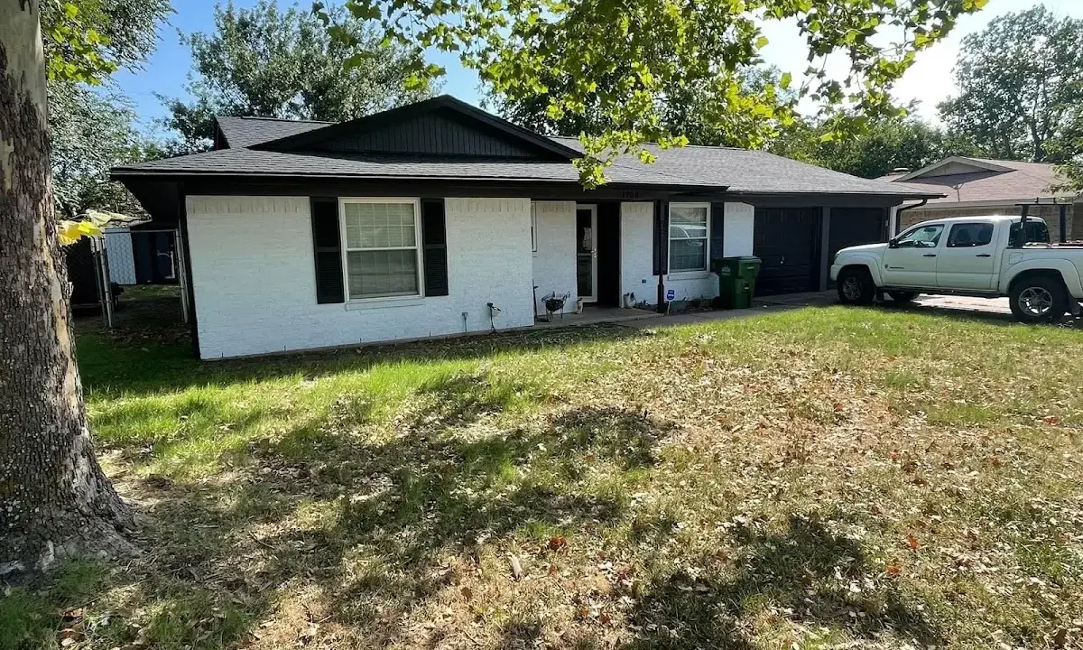 Professional roofing crew working on a residential roof in Longview